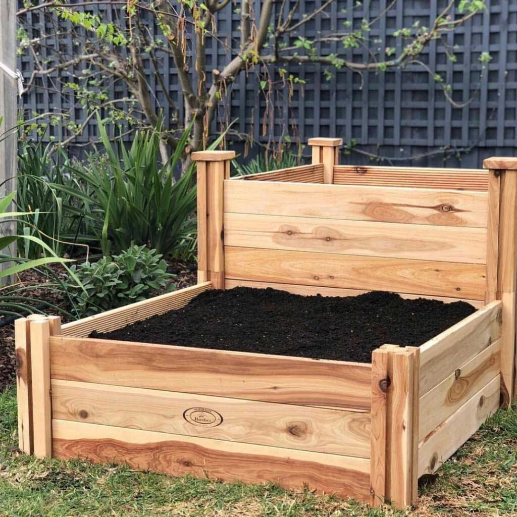 Raised timber garden beds filled with dirt in a garden