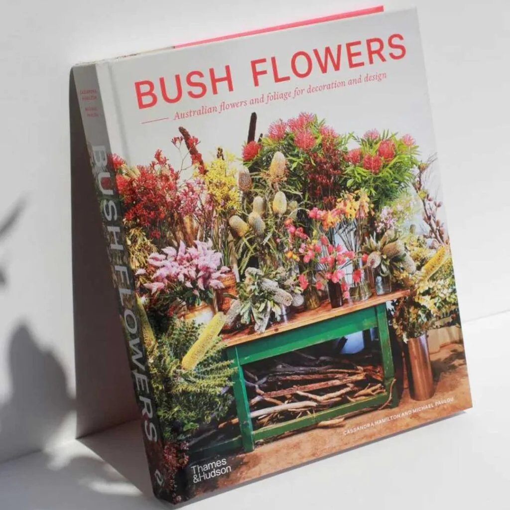 Bush Flowers Book featuring a table willed with Australian native flowers on the cover.,