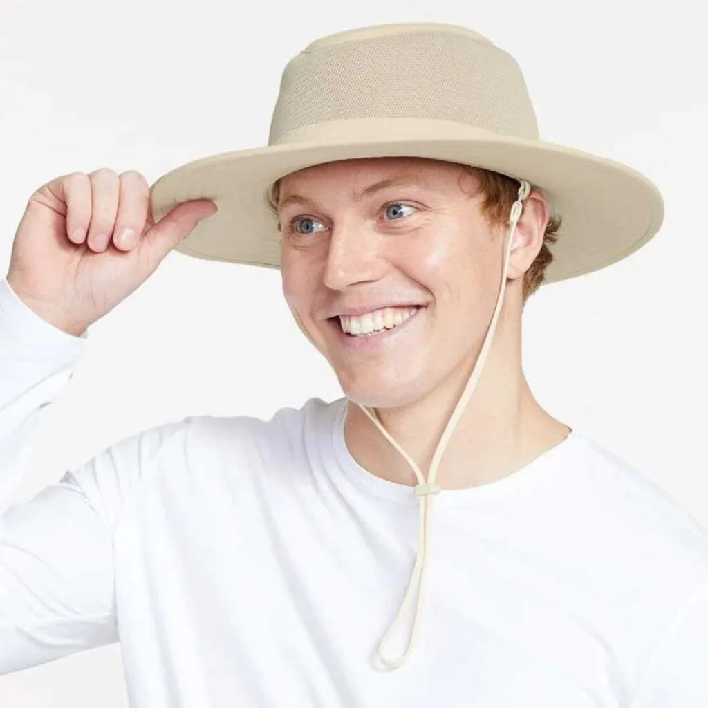 A man wearing a cream coloured broad brimmed sun hat.